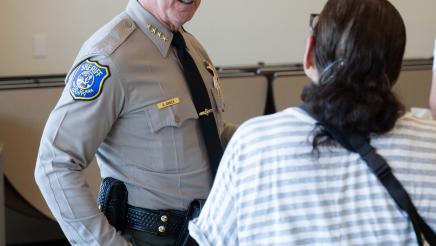 Attendee standing with local officer at the event