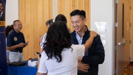 Attendee greeting with Assemblymember Low