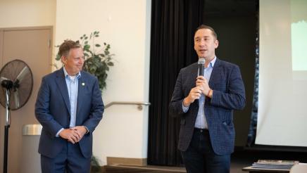 Guest speakers on stage at the town hall