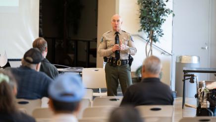 Local police officer speaking at the event