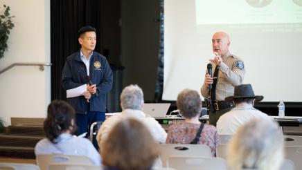 Asm. Low and local officer speaking on stage