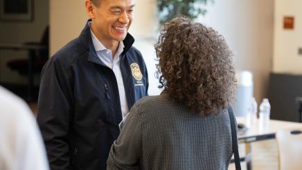 Asm. Low greeting attendees at the event