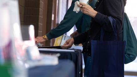 Attendees looking at one of the tables set up at the event