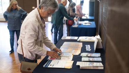 Attendee looking at one of the tables set up at the event