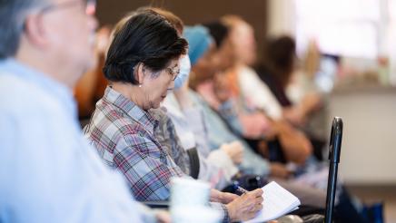 Attendee taking notes at the event