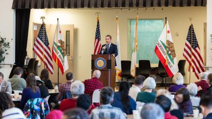 Asm. Ahrens speaking at event Policy and Pancakes