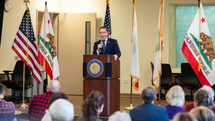 Asm. Ahrens speaking at event Policy and Pancakes