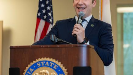 Asm. Ahrens speaking at event Policy and Pancakes