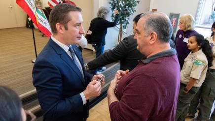 Asm. Ahrens speaking with constituent at the event