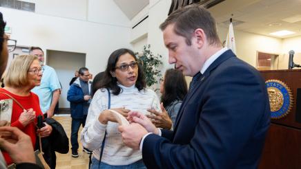 Asm. Ahrens speaking with constituent at the event