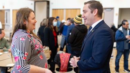 Asm. Ahrens speaking with constituent at the event